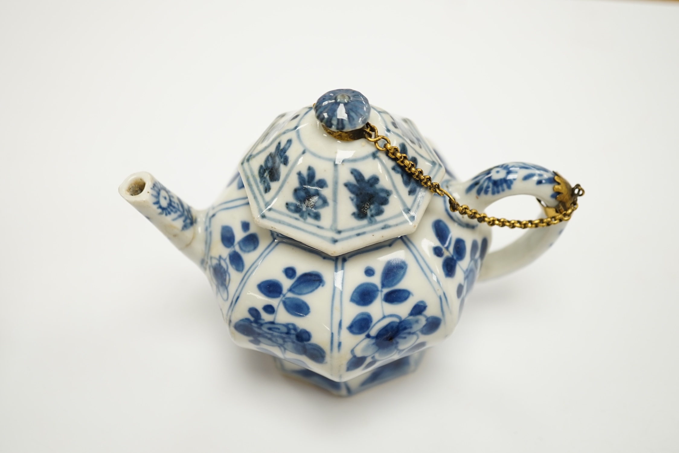 A Chinese blue and white octagonal teapot and cover with gilt metal mounts and a blue and white baluster vase, 16.5cm high, both 18th century